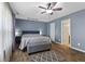 Main bedroom featuring a ceiling fan, wood floors, and ensuite access at 6159 Connie Ct, Indianapolis, IN 46237