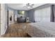 Spacious primary bedroom with ensuite access, wood floors, ceiling fan, and area rug at 6159 Connie Ct, Indianapolis, IN 46237