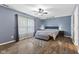 Primary bedroom featuring a ceiling fan, wood floors, and ample sunlight at 6159 Connie Ct, Indianapolis, IN 46237