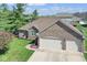 Lovely brick home featuring an attached two-car garage and blossoming landscaping at 6232 Buck Trail Rd, Indianapolis, IN 46237
