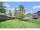 Spacious backyard features lawn and mature trees at 6232 Buck Trail Rd, Indianapolis, IN 46237