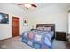 Cozy bedroom featuring a wood-framed bed with patterned quilt and matching furnishings at 6232 Buck Trail Rd, Indianapolis, IN 46237