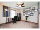 Bedroom featuring ceiling fan, desk and chair, and wall décor at 6232 Buck Trail Rd, Indianapolis, IN 46237