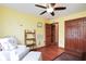 Bright bedroom features hardwood floors, ceiling fan, closet and charming decor at 6232 Buck Trail Rd, Indianapolis, IN 46237