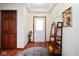 Inviting foyer with hardwood floors, decor shelving, and views of the front door at 6232 Buck Trail Rd, Indianapolis, IN 46237