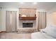 Close-up of the brick fireplace with a wooden mantel and decorative items at 6232 Buck Trail Rd, Indianapolis, IN 46237