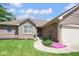 Charming single-story brick home with well-maintained lawn and flowerbeds at 6232 Buck Trail Rd, Indianapolis, IN 46237