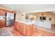 Eat-in kitchen features an island with seating and views of the living room at 6232 Buck Trail Rd, Indianapolis, IN 46237