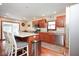 Kitchen with an island, seating, stainless steel appliances, and sliding doors to the exterior at 6232 Buck Trail Rd, Indianapolis, IN 46237