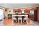 Kitchen with wooden cabinets, stainless steel appliances, and breakfast bar seating at 6232 Buck Trail Rd, Indianapolis, IN 46237