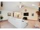 Bright living room featuring neutral tones, vaulted ceiling, ceiling fan, and large sofa at 6232 Buck Trail Rd, Indianapolis, IN 46237