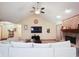 Inviting living room features a vaulted ceiling, ceiling fan, fireplace, and neutral decor at 6232 Buck Trail Rd, Indianapolis, IN 46237