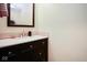 Stylish powder room features a dark wood vanity with a white countertop at 6232 Buck Trail Rd, Indianapolis, IN 46237