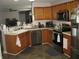 Well-equipped kitchen with modern appliances and wooden cabinets at 6350 Emerald Springs Dr, Indianapolis, IN 46221