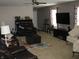 Inviting living room with dark furniture, neutral walls, and a ceiling fan at 6350 Emerald Springs Dr, Indianapolis, IN 46221