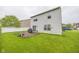 Backyard view featuring an elevated deck, grass, and white-sided two-story home at 6376 Matcumbe Way, Plainfield, IN 46168