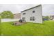 Backyard view featuring an elevated deck, grass, and white-sided two-story home at 6376 Matcumbe Way, Plainfield, IN 46168