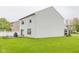 Large backyard with a wooden deck attached to a white vinyl sided two-story house at 6376 Matcumbe Way, Plainfield, IN 46168