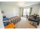 Bright bedroom with neutral walls, a single bed, and a desk near the window at 6376 Matcumbe Way, Plainfield, IN 46168