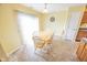 Bright dining room with a wooden table, chair seating, sliding glass door, and ceramic tile flooring at 6376 Matcumbe Way, Plainfield, IN 46168