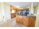 Open concept kitchen with a center island, wood cabinets, and ceramic tile flooring at 6376 Matcumbe Way, Plainfield, IN 46168