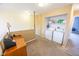 Upstairs laundry area with carpeted floor, desk and white washer and dryer at 6376 Matcumbe Way, Plainfield, IN 46168
