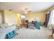 Open living room featuring neutral walls, plush carpeting, ceiling fan, and ample natural light at 6376 Matcumbe Way, Plainfield, IN 46168