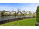 Scenic backyard view of a pond, fenced yard, and neighborhood homes at 6514 Trevia Ct, Indianapolis, IN 46236