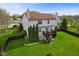 Spacious backyard featuring a wood deck, manicured lawn, privacy fencing, and mature trees at 6514 Trevia Ct, Indianapolis, IN 46236