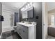 Updated bathroom showcasing double sink vanity with granite counters and tile flooring and shower at 6514 Trevia Ct, Indianapolis, IN 46236