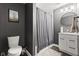 Clean bathroom with a modern vanity, toilet, and a shower with a stylish shower curtain at 6514 Trevia Ct, Indianapolis, IN 46236