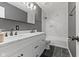 Modern bathroom featuring a double vanity, marble countertop, and tiled shower and flooring at 6514 Trevia Ct, Indianapolis, IN 46236