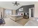 Spacious bedroom with a vaulted ceiling, a large bed, and ample natural light from a window at 6514 Trevia Ct, Indianapolis, IN 46236