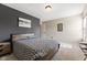 Bedroom featuring neutral carpet, natural light, and a decorative accent wall at 6514 Trevia Ct, Indianapolis, IN 46236