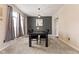 Elegant dining room showcases a modern chandelier, striking accent wall, and seating for four near window at 6514 Trevia Ct, Indianapolis, IN 46236