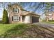 Well-maintained two-story home with a brick and siding exterior, a two-car garage, and a green front lawn at 6514 Trevia Ct, Indianapolis, IN 46236
