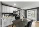 Charming kitchen with white cabinets, modern appliances, and a cozy dining area with a table and chairs at 6514 Trevia Ct, Indianapolis, IN 46236