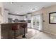 Bright kitchen features stainless steel appliances, granite counters, bar seating, and french doors to backyard at 6514 Trevia Ct, Indianapolis, IN 46236
