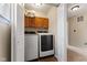 Functional laundry room featuring a modern washer and dryer, and upper cabinet storage at 6514 Trevia Ct, Indianapolis, IN 46236