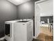 Convenient laundry room with modern washing machines and a doorway leading to other areas of the home at 6514 Trevia Ct, Indianapolis, IN 46236