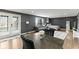 Open-concept living space features gray walls, wood floors, and a comfortable sitting area, along with a modern table setting at 6514 Trevia Ct, Indianapolis, IN 46236