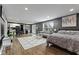 Open-concept living and bedroom with kitchen area, modern furniture, and large windows, maximizing space at 6514 Trevia Ct, Indianapolis, IN 46236