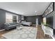 Modern bedroom featuring sleek furniture, a TV, and a large window creating a comfortable and stylish space at 6514 Trevia Ct, Indianapolis, IN 46236