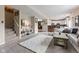 Cozy living room featuring a carpet, stairs, and an open layout leading to the kitchen and dining area at 6514 Trevia Ct, Indianapolis, IN 46236