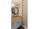 Charming powder room featuring decorative mirror, granite counter, and a stylish vanity, optimizing small space at 6514 Trevia Ct, Indianapolis, IN 46236