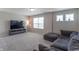 Cozy basement features plush carpet, large windows, and a comfortable sectional sofa at 7144 Hart St, Cumberland, IN 46229
