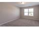 This bedroom features neutral paint, carpet, and a window with blinds for a cozy feel at 7144 Hart St, Cumberland, IN 46229