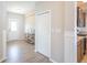 Inviting entryway features hardwood floors, neutral walls, and view of the kitchen area at 7144 Hart St, Cumberland, IN 46229