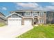 Beautiful two-story home with a three-car garage, brick accents, and a well-manicured lawn at 7144 Hart St, Cumberland, IN 46229