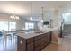 Open-concept kitchen boasts a granite island, stainless dishwasher, and is open to the living area at 7144 Hart St, Cumberland, IN 46229